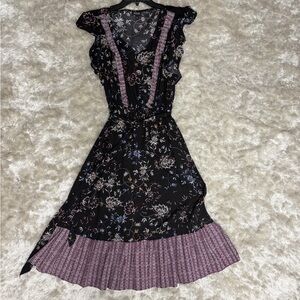 Black and purple floral Prairie Midi Dress with ruffles, pockets, and tie waist